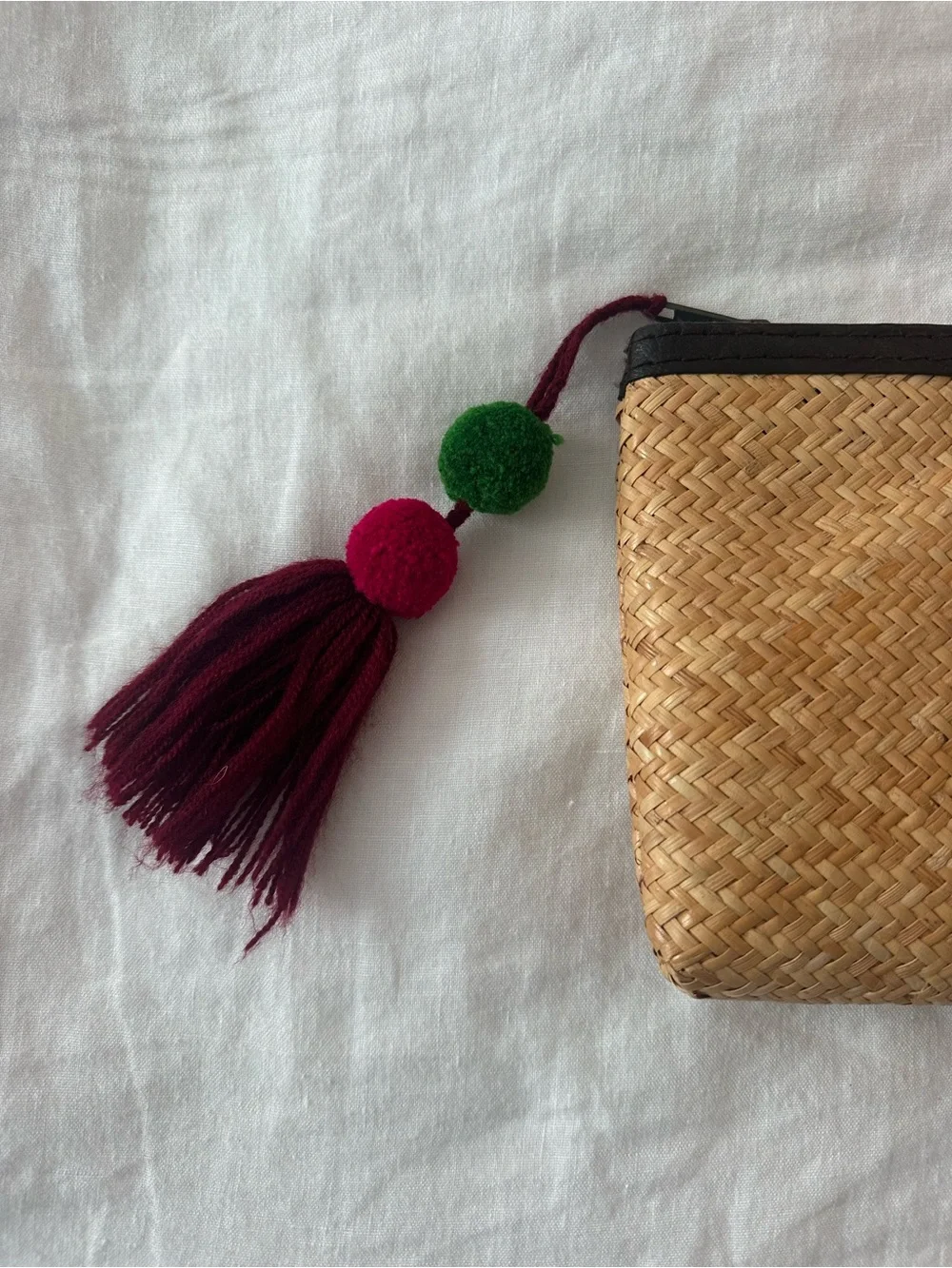 Rattan clutch with pompom zip